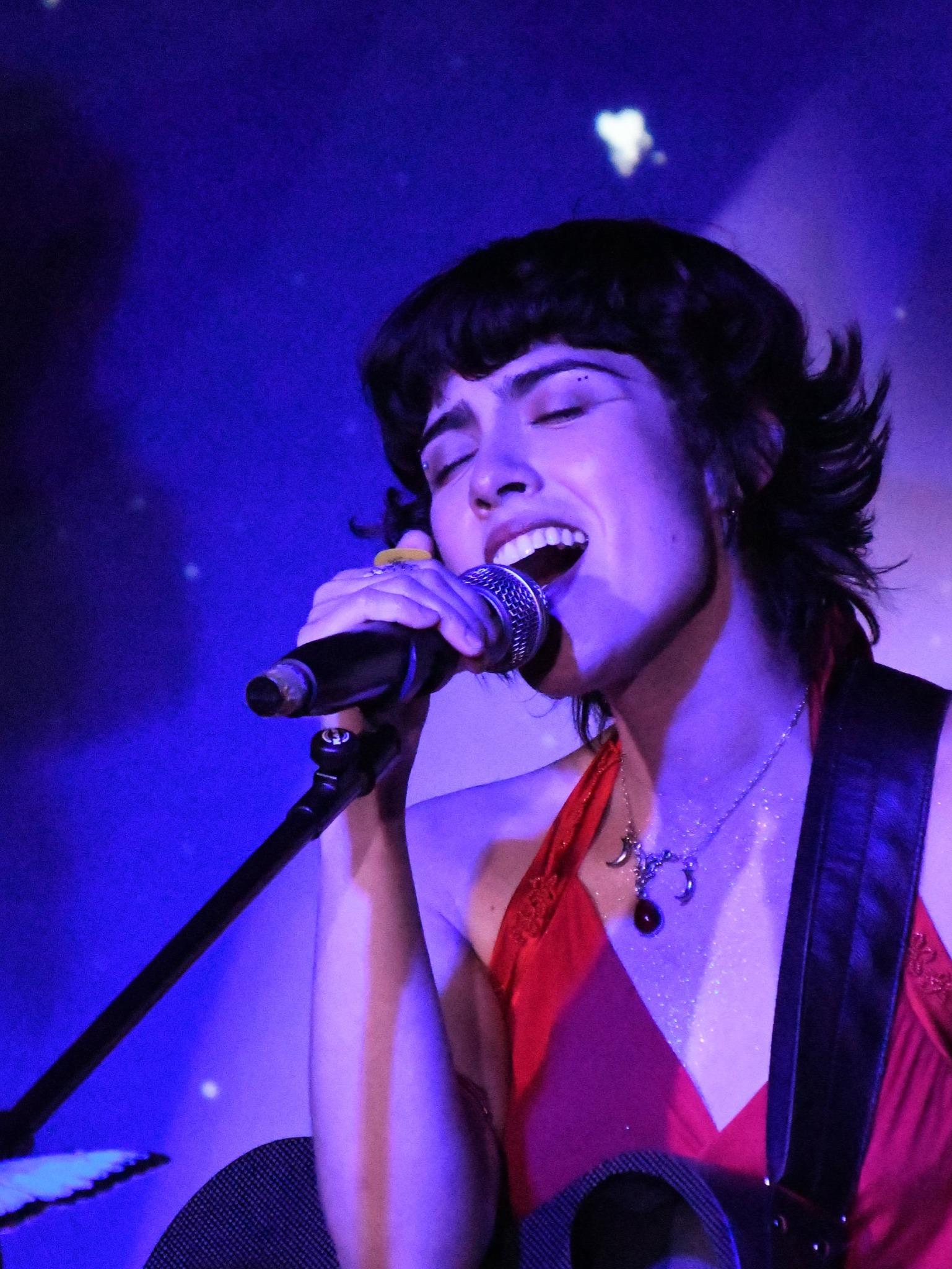 Bianca Isabella singing live under purple stage light