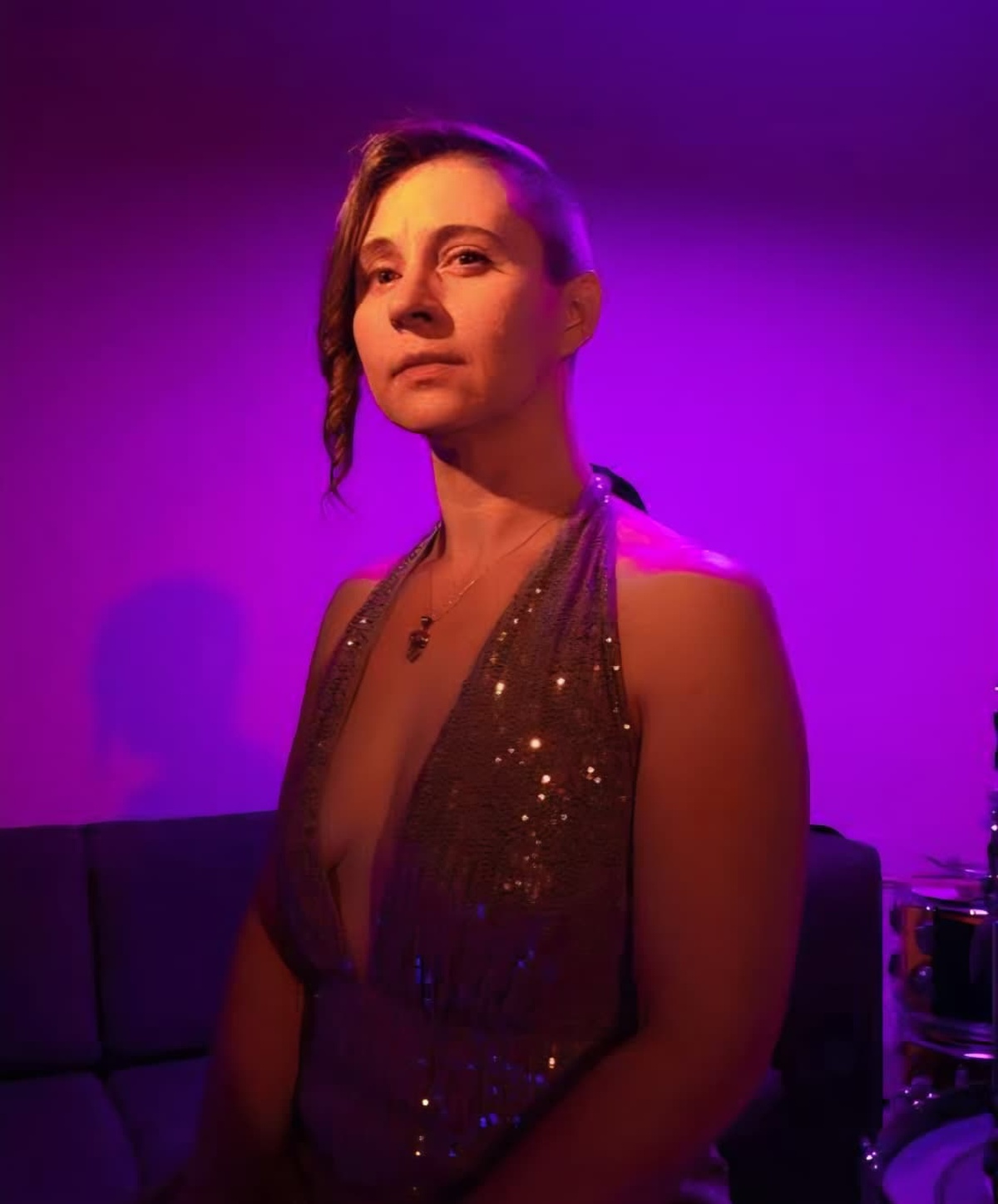 Singer-songwriter Laurelle K posed under purple light